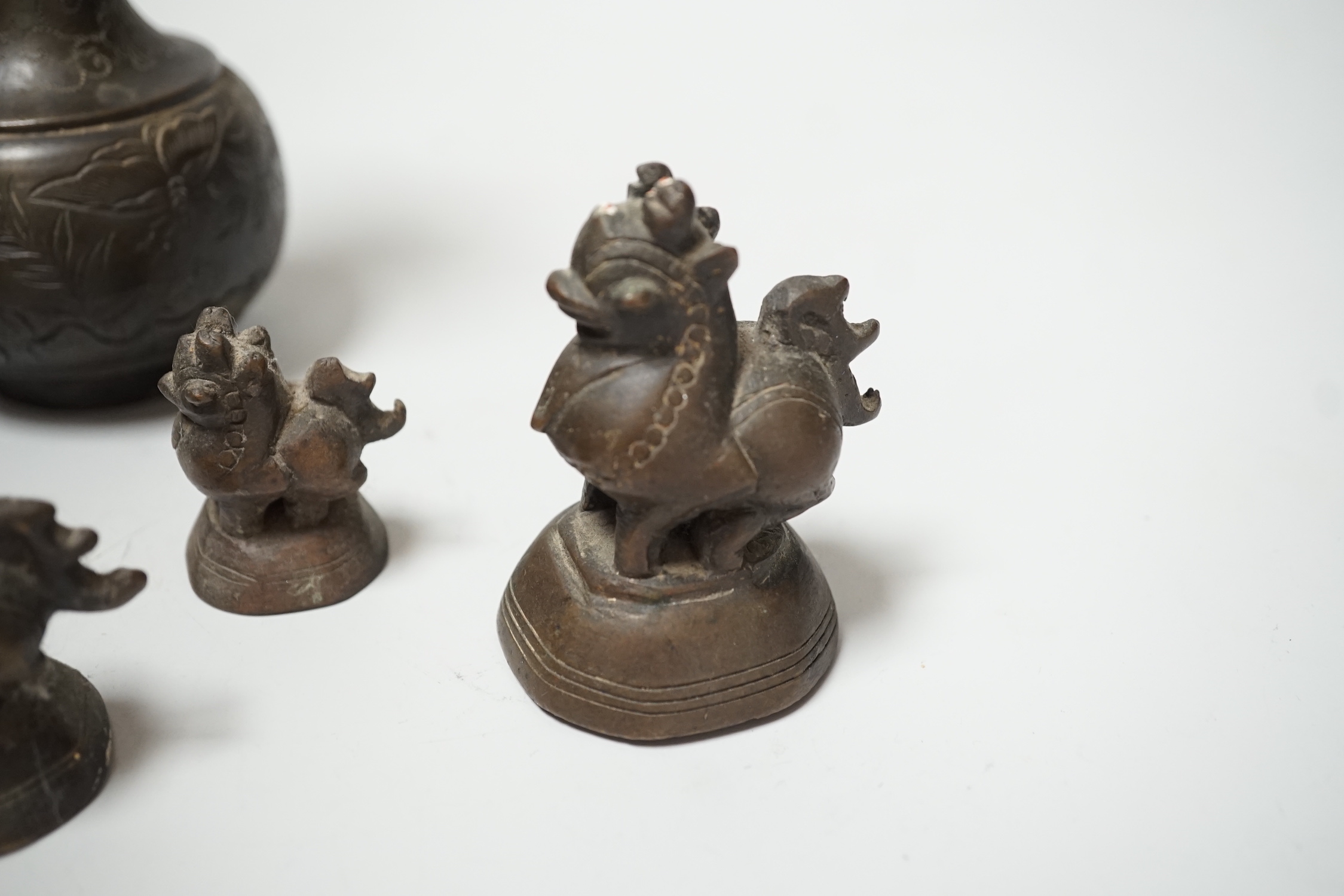 A set of Burmese bronze weights and a pair of bronze vases, 12cm